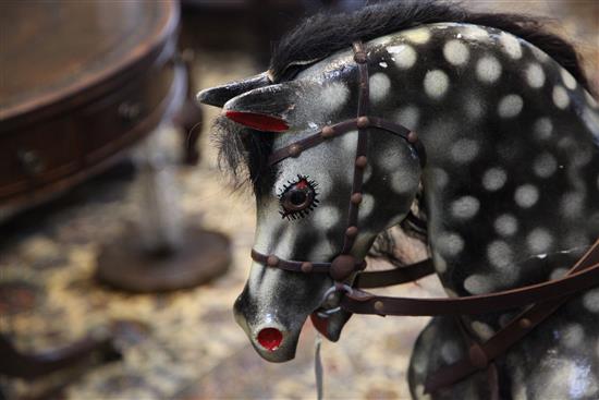 A black and grey painted rocking horse, overall length 6ft 11in.